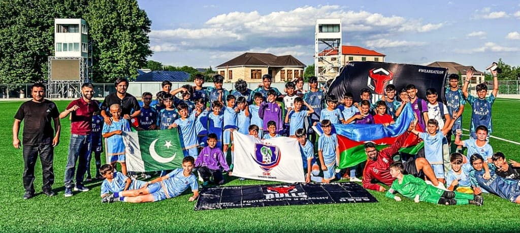 Bulls Baku tour — team on pitch with Pakistan and Azerbaijan flags